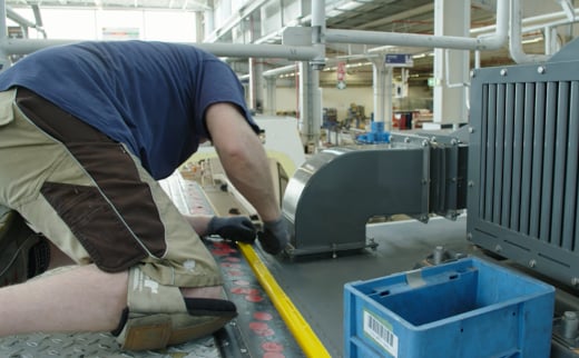Bombardier Employee working with 3D Stratasys part