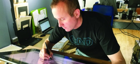 A man sketching at a desk