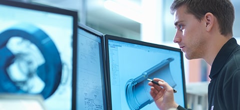 A man creating 3D prints on a computer monitor, creating new products for the Consumer Goods industry