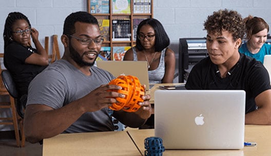 students in a classroom, learning about 3D printing