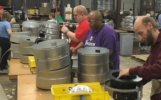 people working in a warehouse, preparing to reuse and recycle 3d printer materials